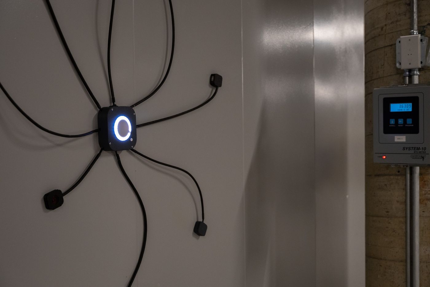 IoT Octopus device on a plant wall with eight sensor cables reaching out to the equipment it monitors